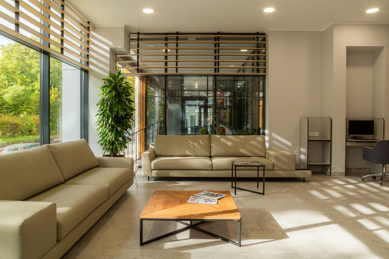 Modern interior with large sun-exposed windows illustrating the benefits of heat-rejecting window film.